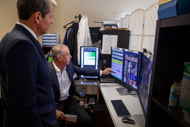 Gov. Brian Kemp (left) views a demonstration of Telmedix technology from Dr. Keith Thompson, who co-founded the company.